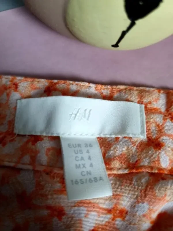 Міді спідниця помаранчевого кольору з квітковим дизайном та розрізом 4